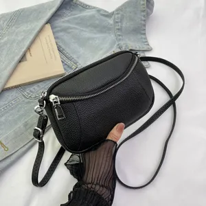 Genuine leather mini crossbody bag for women, stylish black shoulder bag with double zippers.