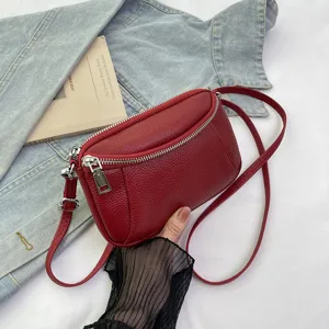 Red leather crossbody bag for women, stylish mini shoulder bag with double zippers and strap.