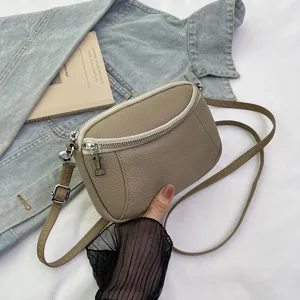 Compact genuine leather crossbody bag for women, stylish double zipper mini shoulder bag.