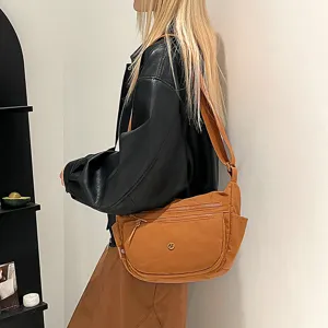 Casual nylon crossbody bag detail, brown multi-compartment shoulder bag, daily commute style.