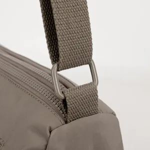 Close-up view of women's nylon shoulder bag strap detail, water-resistant fabric.