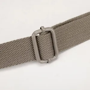 Close-up detail of adjustable shoulder bag strap with metallic buckle, durable canvas design.