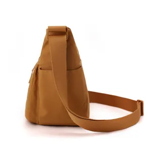 Detail view of the casual nylon crossbody bag showing the adjustable wide strap and side pocket.