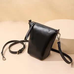 Minimalist black leather shoulder crossbody bag for women with removable strap.
