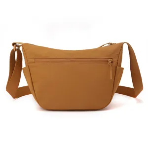 Close-up view of the smooth zipper pocket and durable nylon fabric texture on this casual bag.