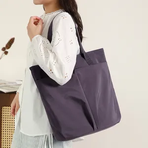 Lightweight nylon shoulder tote bag detail view, waterproof computer bag with front pockets.