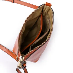 Women's brown leather crossbody shoulder bag with zipper closure and adjustable strap.