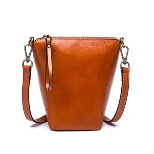 Stylish brown leather bucket shoulder bag for women, simple crossbody handbag with zipper.