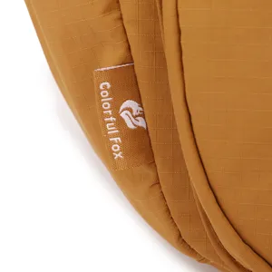 Close-up detail of the durable nylon crossbody bag fabric and brand tag, textured design.