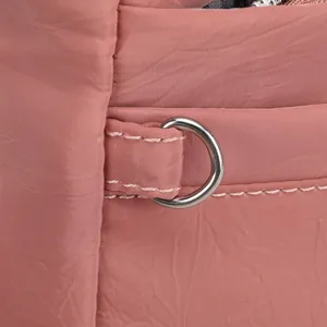 Detailed view of women's nylon shoulder bag in pink with durable hardware and stitching.