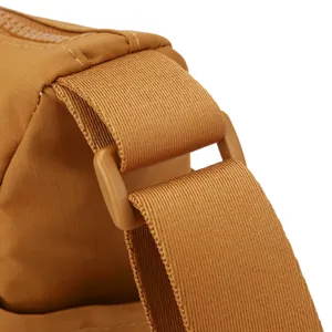 Nylon cross-body bag strap detail, adjustable buckle, durable fabric, khaki color.