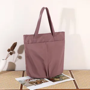 Lightweight waterproof nylon tote bag for women, stylish shoulder bag for work and daily use.