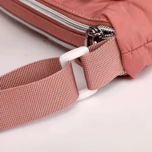 Pink nylon shoulder bag detail view, showing sturdy zipper and strap hardware for women.