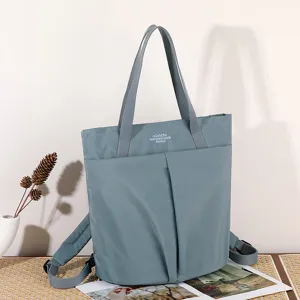 Waterproof nylon laptop handbag, lightweight work tote bag with dual straps and backpack design.