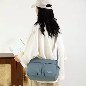 Detailed view of the stylish nylon crossbody bag worn by a model, casual everyday commute.
