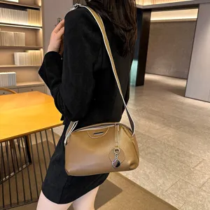 Genuine leather shoulder bag for women, stylish brown crossbody purse with wide strap.