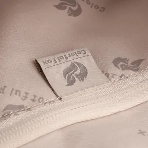 Close-up of bag interior lining and brand woven label, showing fine stitching and details.