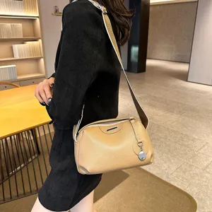 Genuine leather crossbody shoulder bag for women, stylish wide strap design, casual tan.