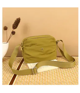 Water-resistant nylon crossbody bag for women, casual multi-pocket olive green shoulder bag.
