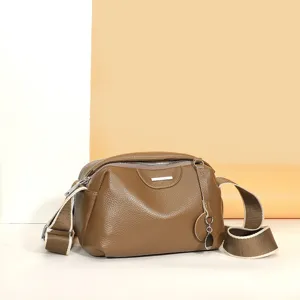 Genuine leather shoulder bag for women, stylish crossbody handbag with wide strap.