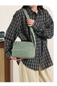 Minimalist light green nylon crossbody shoulder bag, casual everyday fashion handbag for women.