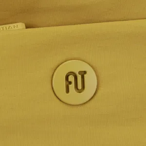 Close-up of yellow nylon shoulder bag detail, highlighting embossed logo and zipper.