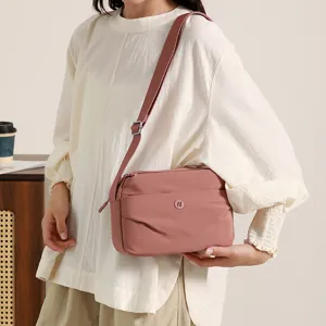 Stylish women's nylon crossbody bag detail, pink casual shoulder bag with adjustable strap.