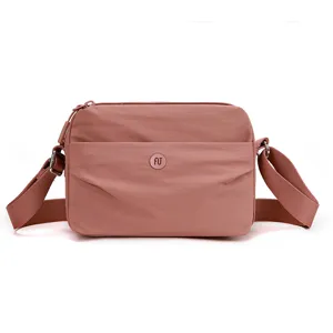 Minimalist waterproof nylon crossbody shoulder bag for women, casual daily wear style.