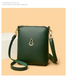 Dark green PU leather phone crossbody bag with gold gourd pendant detail, compact and stylish detail view.