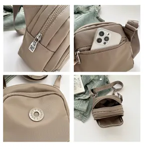Close-up details of the casual nylon crossbody bag, showing multi-compartment zipper and strap.