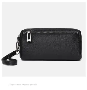 Black genuine leather small crossbody phone bag with wrist strap and metal zipper detail.