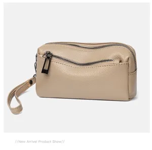Detail view of genuine leather women clutch bag, small double zipper pouch with wrist strap.