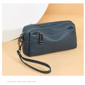 Genuine leather small crossbody bag with multi-zipper compartments and a convenient wrist strap.
