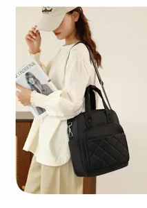 Black nylon quilted convertible backpack detail showing fine stitching and metal hardware.