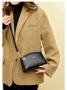 Elegant black leather shell crossbody bag for women, perfect for daily commuting and casual use.