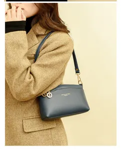 Classic navy blue leather shell shoulder bag for women, elegant daily commute crossbody handbag.