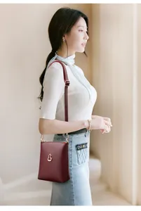 Classic wine red small bucket bag detail view, stylish gourd hardware accent for women.