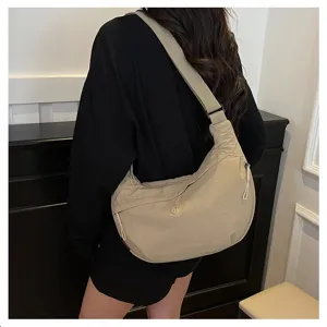 Detailed shot of the casual lightweight nylon crescent crossbody bag worn on shoulder.