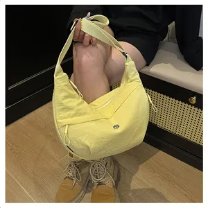 Lightweight nylon crossbody bag with zipper pocket, casual crescent shoulder bag for daily use.