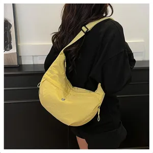Detailed view of the lightweight nylon crossbody dumpling bag in bright yellow color.
