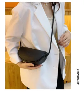 Black genuine leather half moon shoulder crossbody bag showcasing fine texture and slim strap.