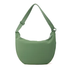 Nylon crossbody bag detail shot, showing smooth zipper, adjustable strap, and durable fabric texture.