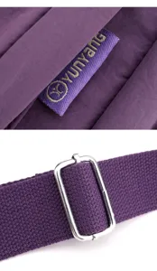 Close-up detail shot showing the durable nylon crossbody bag strap and brand woven label.