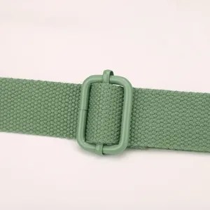 Close up view of the green nylon strap and adjustable metal buckle for stylish crossbody bag.