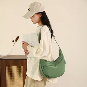 Green nylon crossbody bag for women, lightweight travel shoulder bag with large capacity.