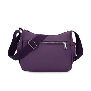 Stylish purple nylon crossbody bag for women with adjustable strap and metal zippers.