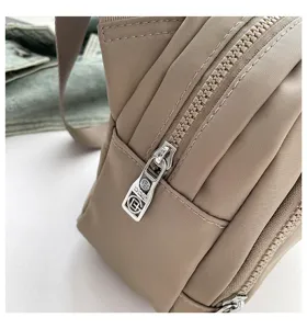 Close-up detail of casual nylon crossbody shoulder bag, highlighting durable zipper and fabric.