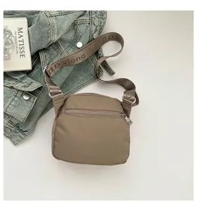 Casual nylon crossbody bag with zipper pocket and stylish shoulder strap for daily commute.