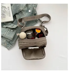Casual nylon crossbody bag with multi-pocket design, adjustable strap and spacious interior compartment.