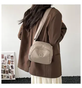 Casual nylon crossbody shell bag detail view, featuring multi-pocket design and wide strap.